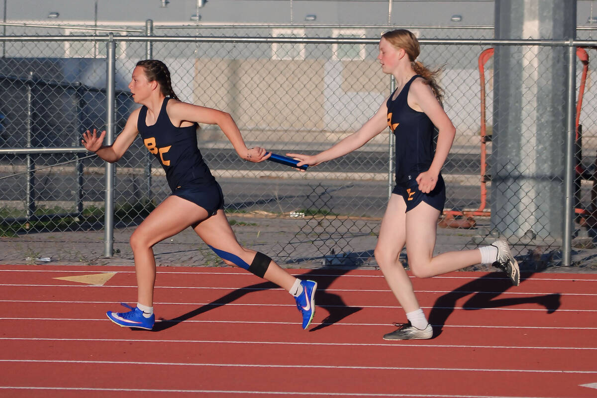 Photo courtesy Mark Misuraca Running in the 4x200 relay, sophomore Hazel Hardy hands the baton ...