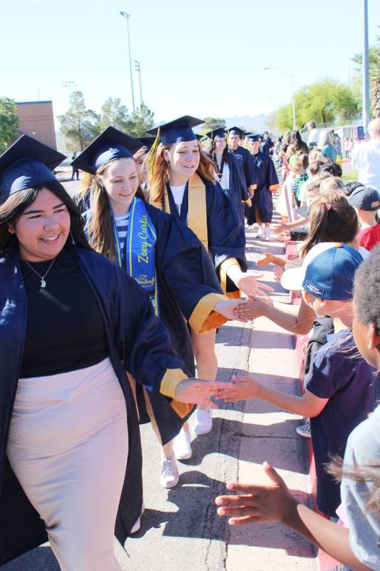 Bethany Gandarilla, Zoey Curtis and Addison Doane give high-fives to students from Andrew Mitch ...