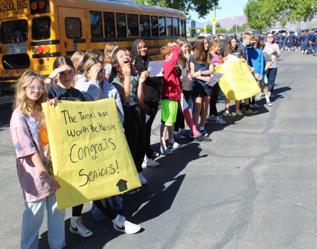 Garrett Junior High students Courtney Brown and Charlotte Tanner hold a sign as the high school ...