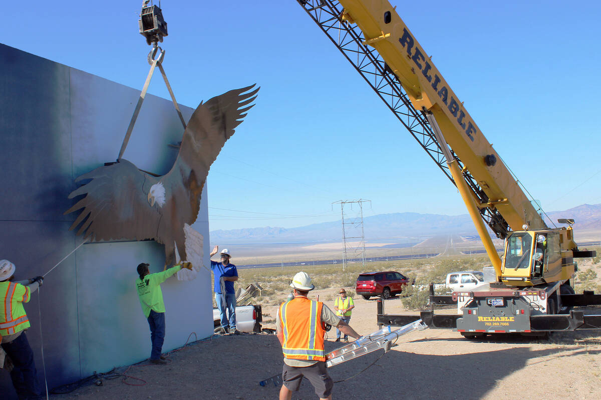 Crane operator Danny McKay, a 1987 BCHS grad, slowly moves the eagle into place as city crews h ...