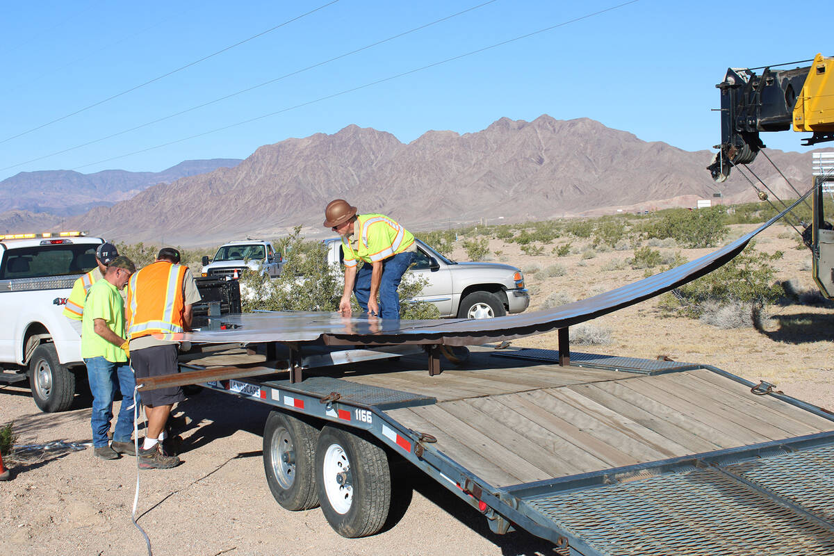 The eagle was brought in on a flatbed trailer. Here, city crews help position it before attachi ...