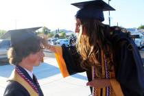 Megan Uszynski lends a helping hand to Lane Pusko with his cap before individual photos.