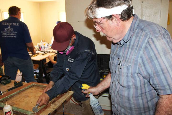 Ron Eland/Boulder City Review Bob Yapp, right, assists Friday with the removal of paint from th ...