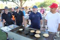 Nevada State Treasurer Zach Conine shows his pancake flipping skills Thursday. He was one of ma ...