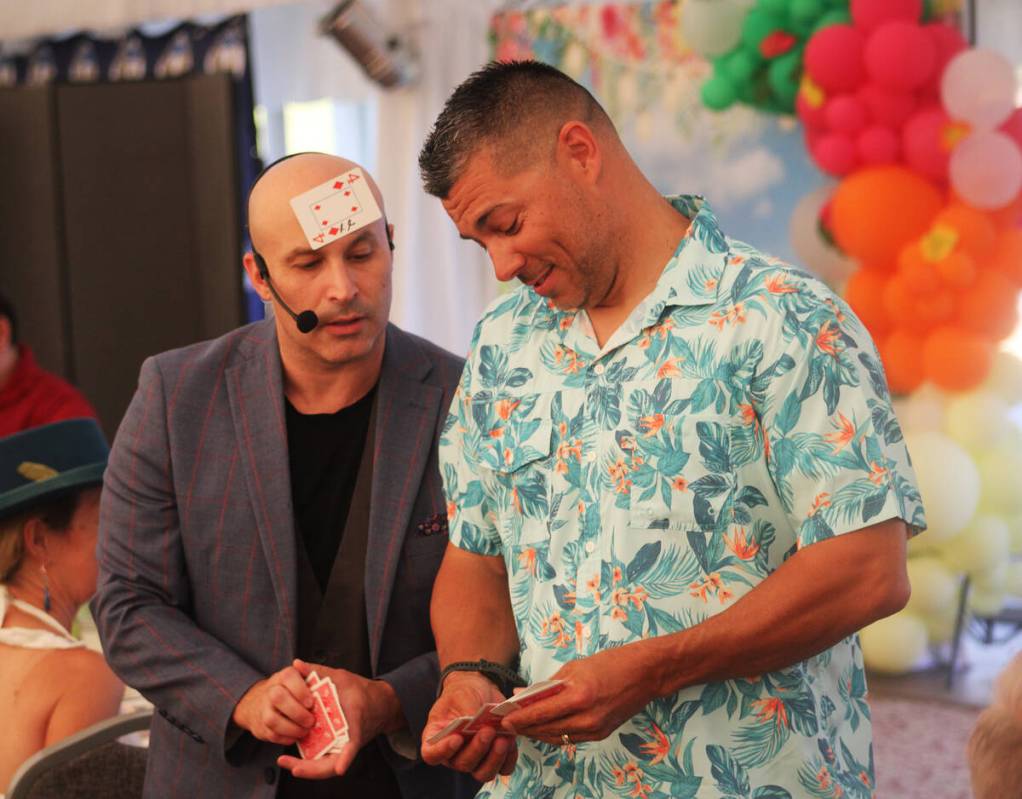 Ron Eland/Boulder City Review Magician Seth Grabel, left, gets assistance from Robert Skirtson ...