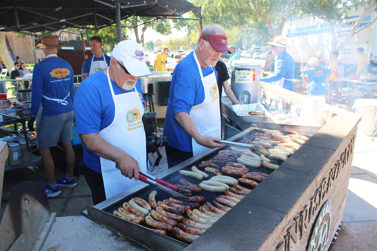 Photos by Ron Eland/Boulder City Review Rotarians Roger Hall and Doug Scheppmann help cook up ...