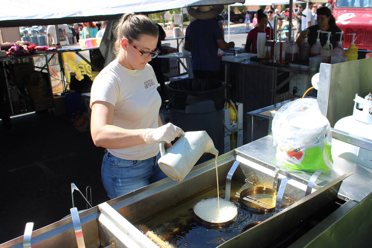 Samantha Santos, of America’s Best Funnel Cakes, prepares one of their of their fried namesakes.