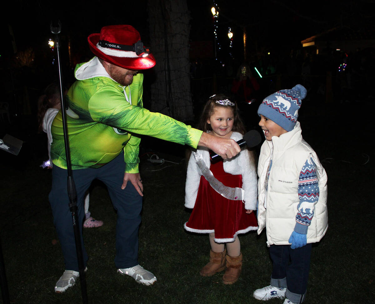 Emcee Joe Stubitz talks with this year’s Little Miss and Mr. Boulder City, Emily Steinman and ...