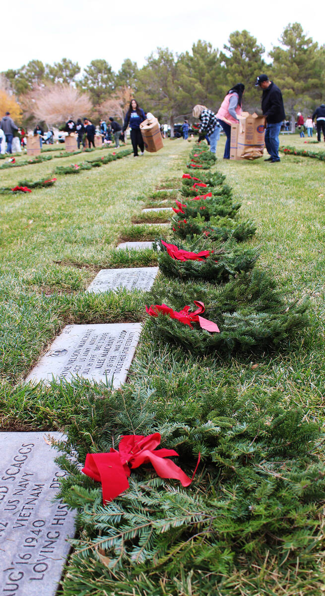 Volunteers went row by row placing the wreaths.