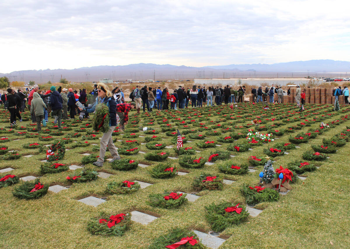 Volunteers were broken into several groups through the cemetery. Here, many wait in line to be ...