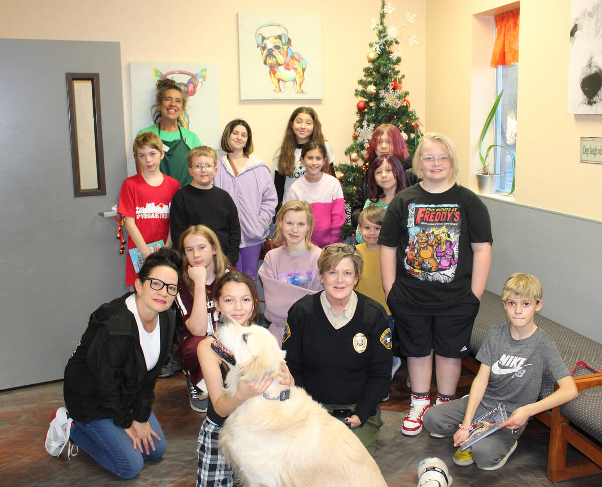 Boulder City Animal Shelter Supervisor Ann Innabnit, below center, is joined by many of the chi ...