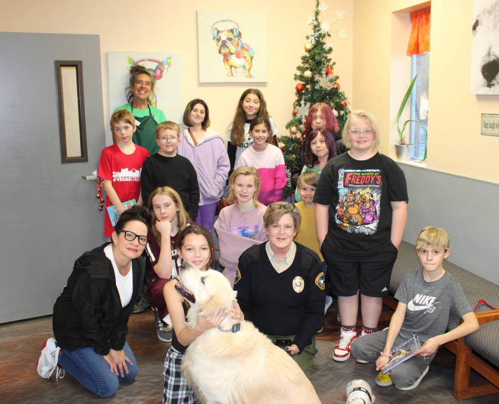 Boulder City Animal Shelter Supervisor Ann Innabnit, below center, is joined by many of the chi ...