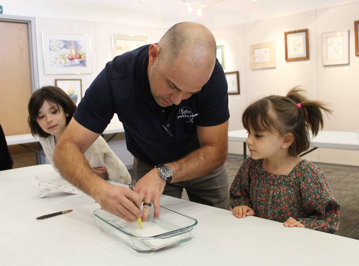 Ron Eland/Boulder City Review Paul Fisher, with his daughters Gyda and Josie watching, showed h ...