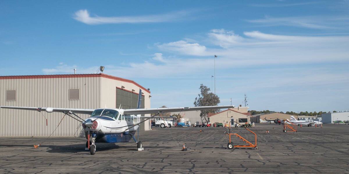 Ian Cruz/Boulder City Review A small passenger plane sits tied down outside a hangar at the Bou ...