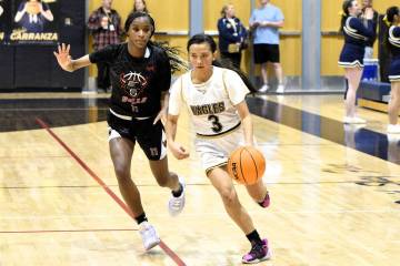 Robert Vendettoli/Boulder City Review Pushing the ball up court, Christine Mojado drives past a ...