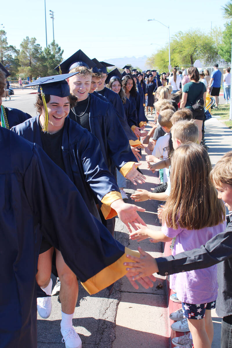 Ron Eland/Boulder City Review Students from Mitchell Elementary lined the street to give passin ...