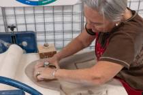 Ian Cruz/Boulder City Review Julie Connell cuts and flattens clay for tile-making. The demonsta ...