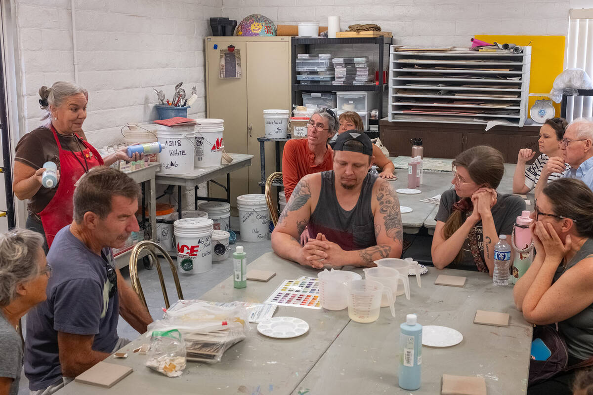 Ian Cruz/Boulder City Review Tile-making attendees listen intently to Julie Connell as she spea ...