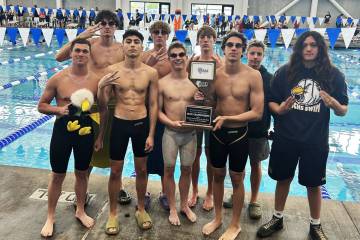 Photo courtesy Sara Carroll Boulder City High School boys swim team celebrates their third cons ...