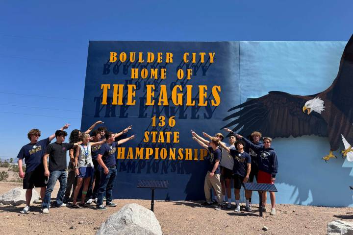 Photo courtesy BCHS Members of the BCHS boys swim team point at the updated state championship ...