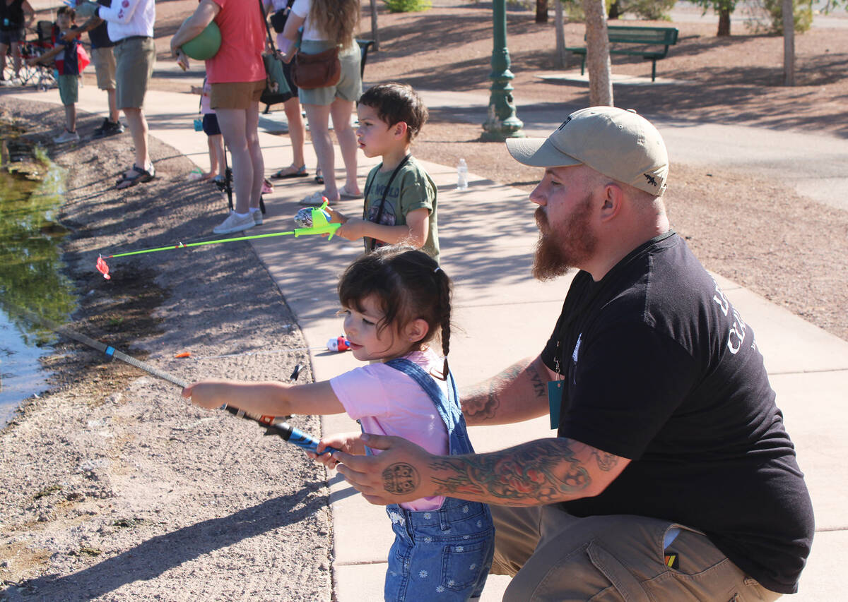 Logan Davis, along with his kids Winter and Maverick, tried their best to catch a fish Saturday ...