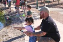 Logan Davis, along with his kids Winter and Maverick, tried their best to catch a fish Saturday ...