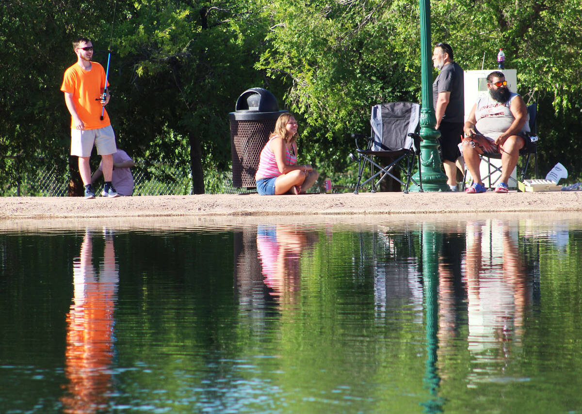 By 8 a.m. there were nearly 100 anglers at the pond to take part in the city's free fish day.