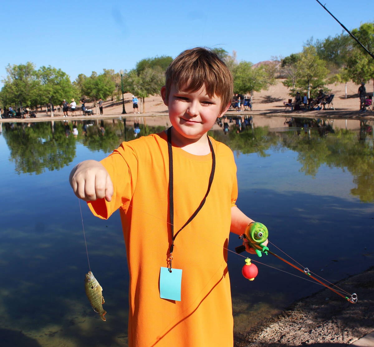 Franklyn McArthur was very proud of his catch, which his father promptly returned to the pond b ...