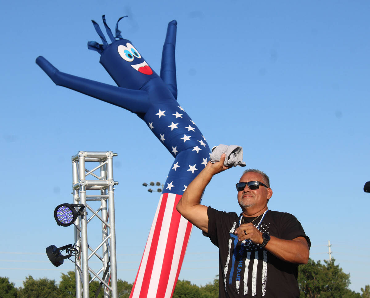 DJ Mike Pacini tosses a T-shirt as he again led the fun at the Veterans Park with his music and ...