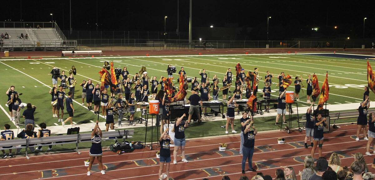 The BCHS marching band and the color guard perform for a full crowd during halftime.