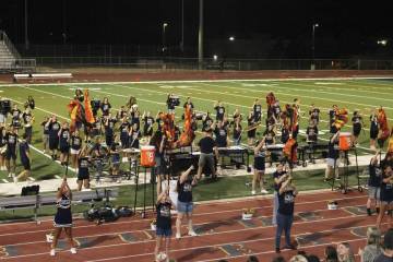 The BCHS marching band and the color guard perform for a full crowd during halftime.