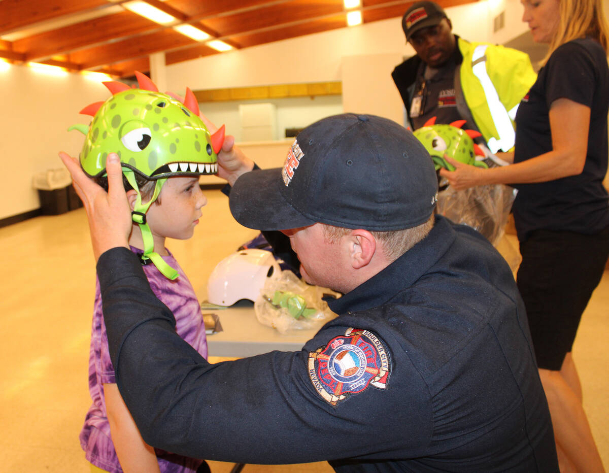 Photos by Ron Eland/Boulder City Review Boulder City Fire Department's Capt. Josh Barrone helps ...