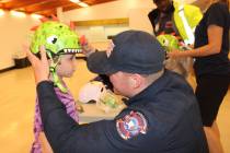 Photos by Ron Eland/Boulder City Review Boulder City Fire Department's Capt. Josh Barrone helps ...