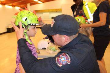Photos by Ron Eland/Boulder City Review Boulder City Fire Department's Capt. Josh Barrone helps ...