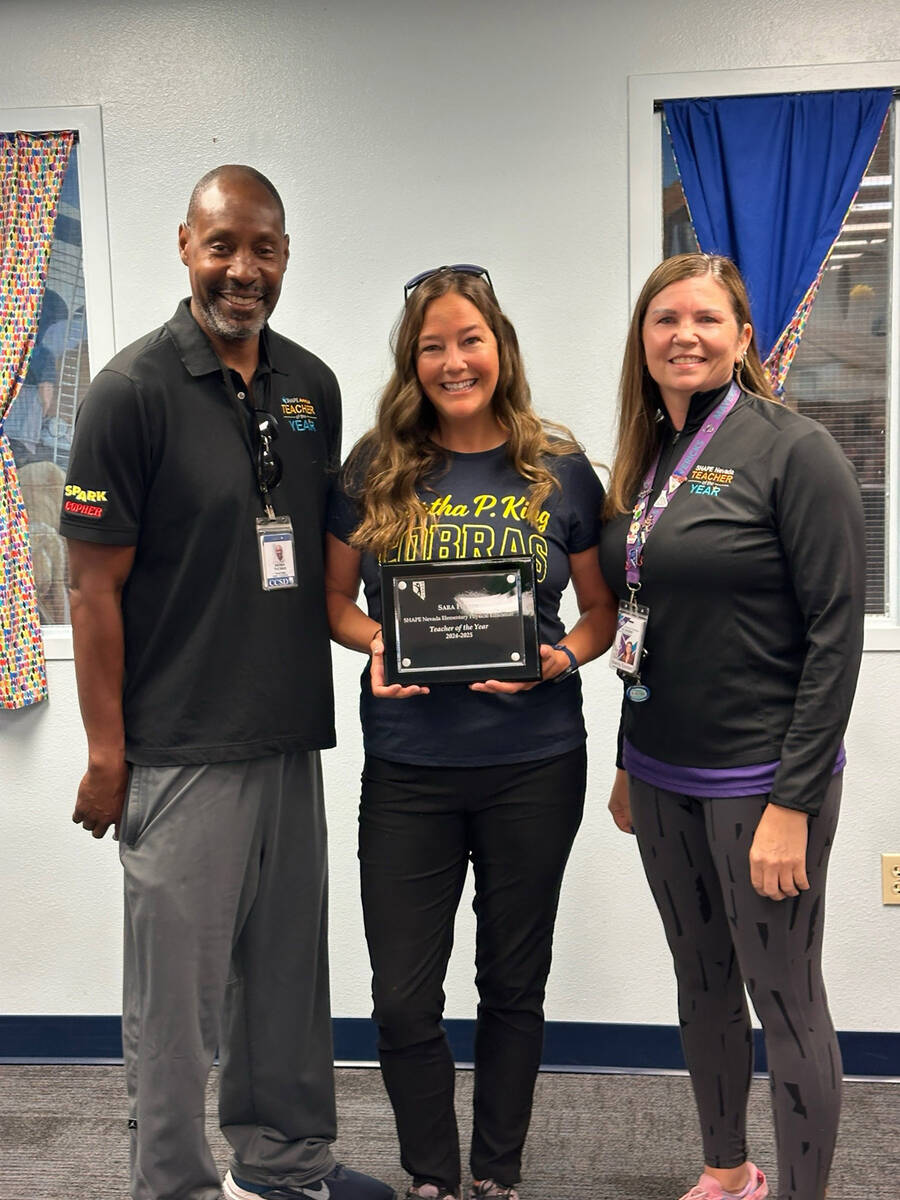 Courtesy photo Sara Fisher, center, is joined by Derek Thomas, last year’s Nevada P.E. teache ...