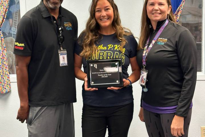 Courtesy photo Sara Fisher, center, is joined by Derek Thomas, last year’s Nevada P.E. teache ...