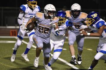 Robert Vendettoli/Boulder City Review Running back Coen Burrows makes his way up field in a 30- ...