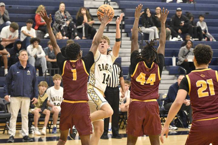 Robert Vendettoli/Boulder City Review Noah Lund shoots over a pair of Del Sol defenders in a 55 ...