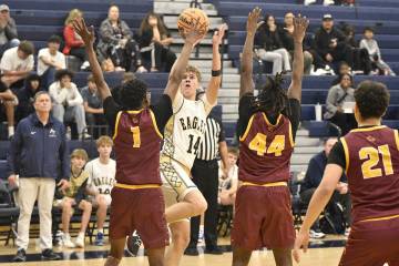 Robert Vendettoli/Boulder City Review Noah Lund shoots over a pair of Del Sol defenders in a 55 ...