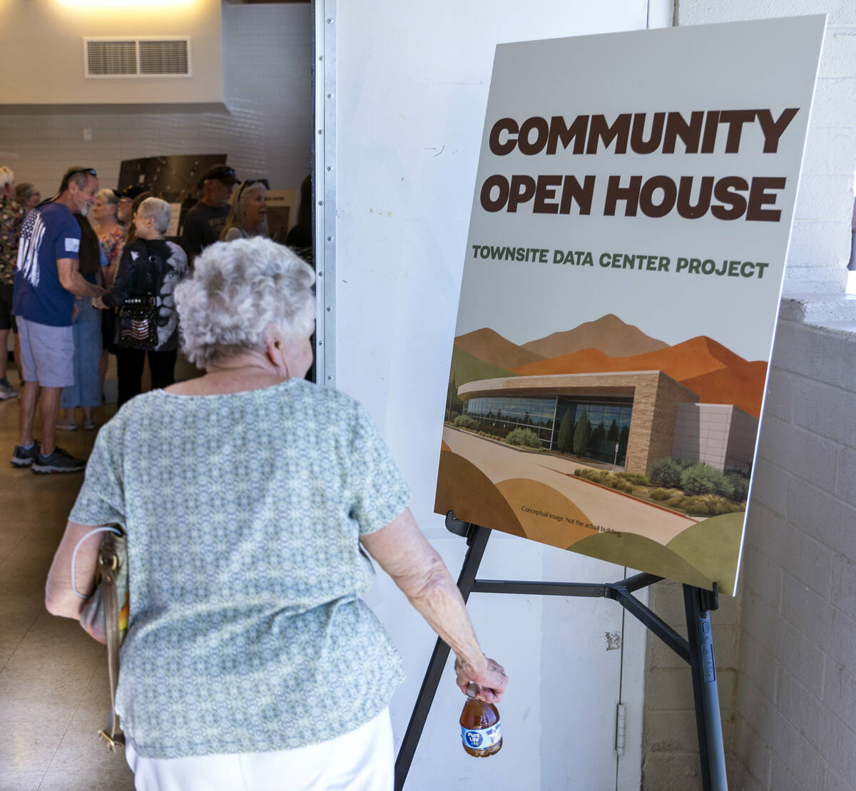 Residents and other concerned citizens look at information boards during a proposed data center ...
