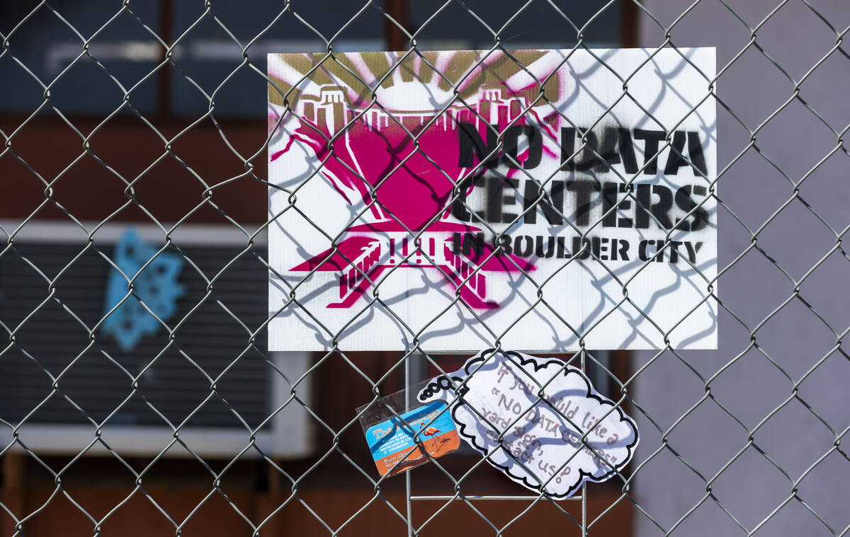 The gated Flamingo Inn Motel has "No Data Centers" signs around it as project represe ...
