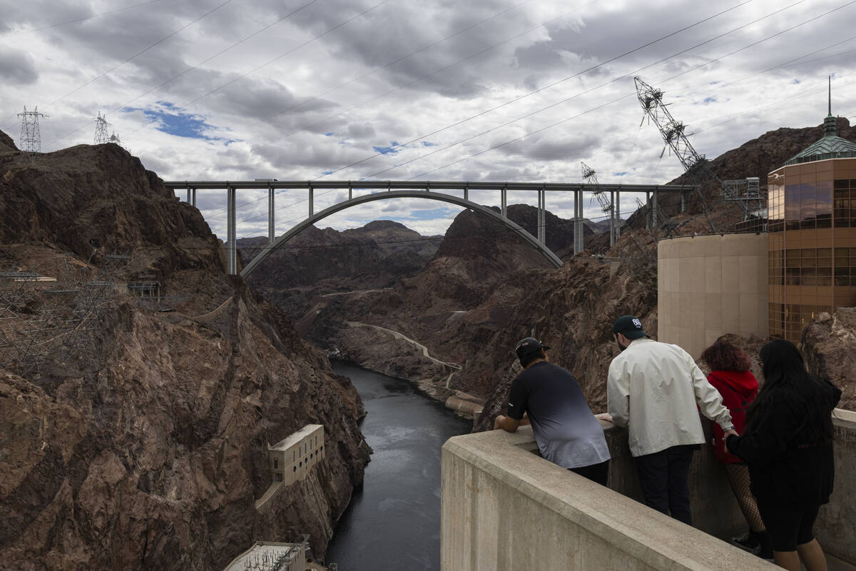People look down at the Colorado River as it flows out from Hoover Dam on Sunday, April 26, 202 ...