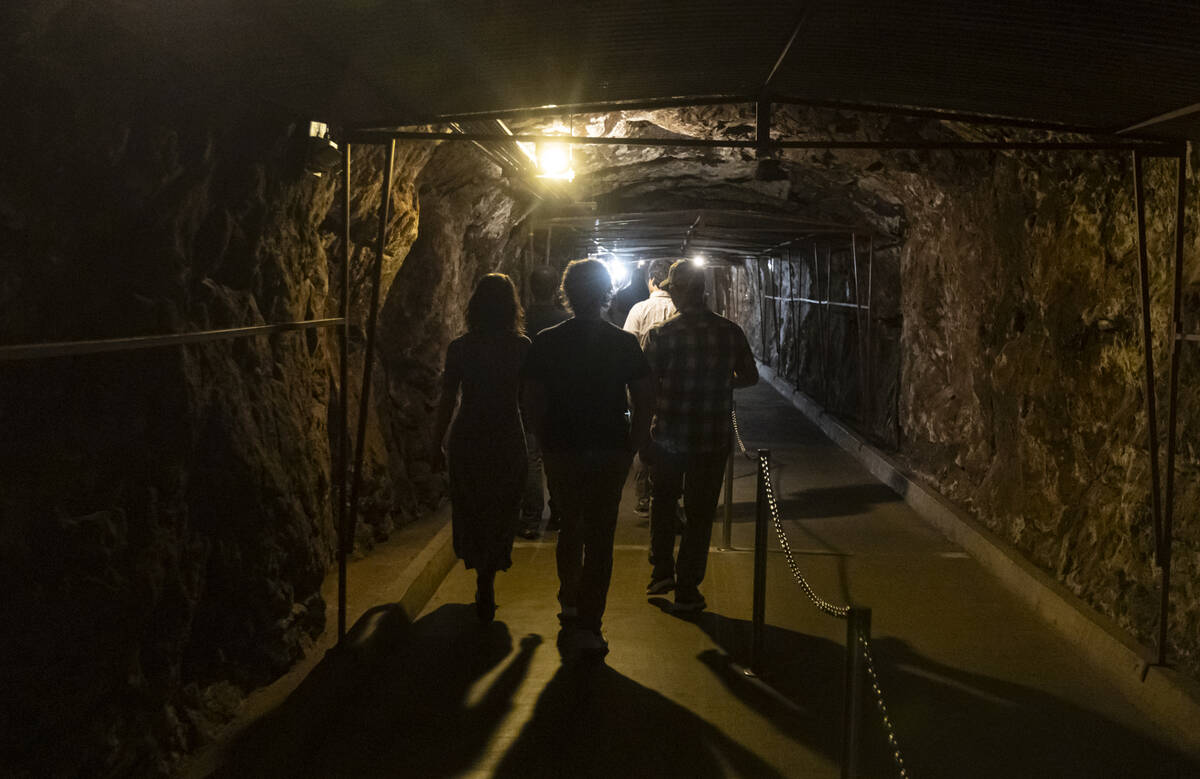 People walk through a tunnel during a guided tour of the Hoover Dam on Sunday, April 26, 2026, ...