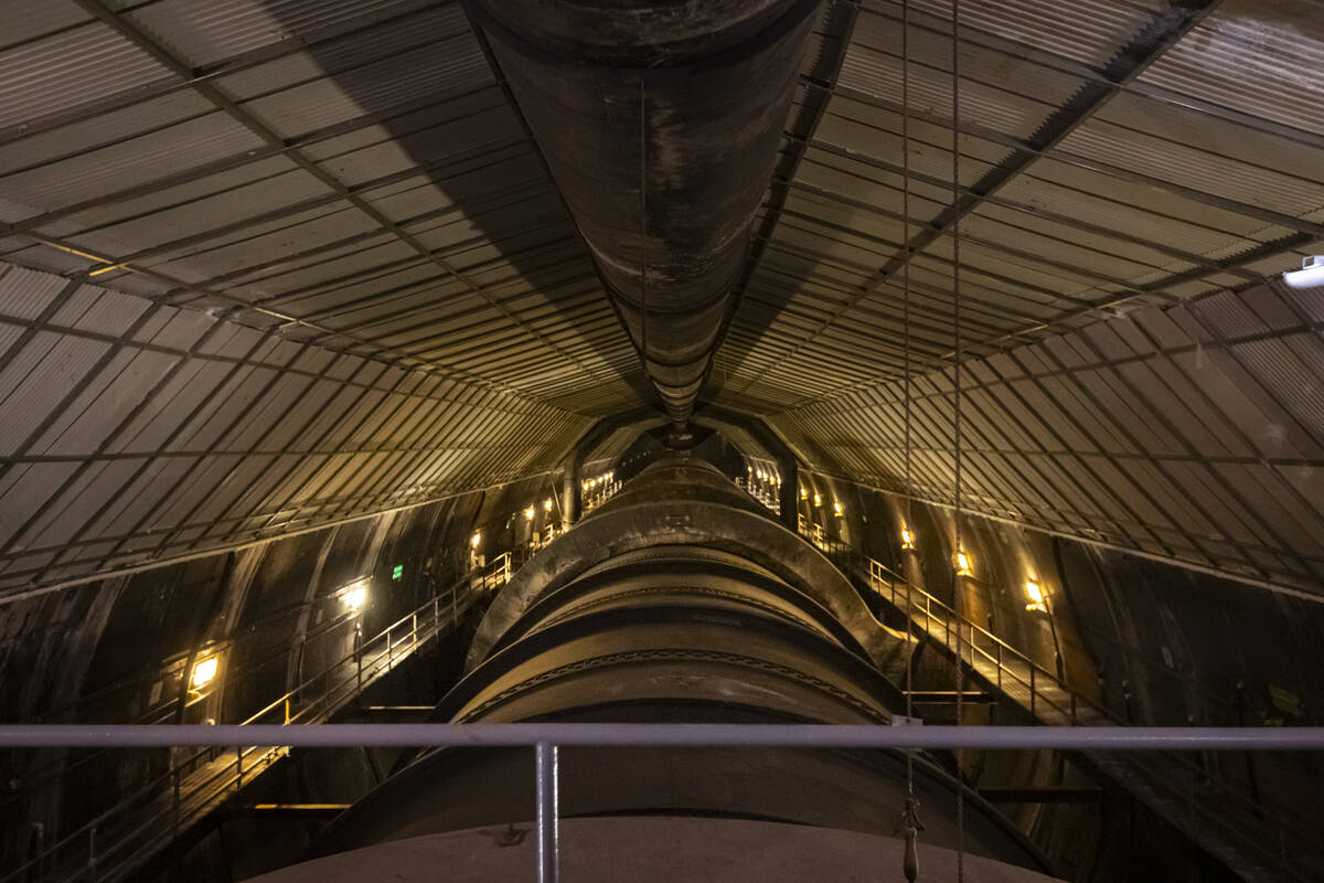 A penstock, which transports water to the power plant, is seen from a spillway tunnel during a ...