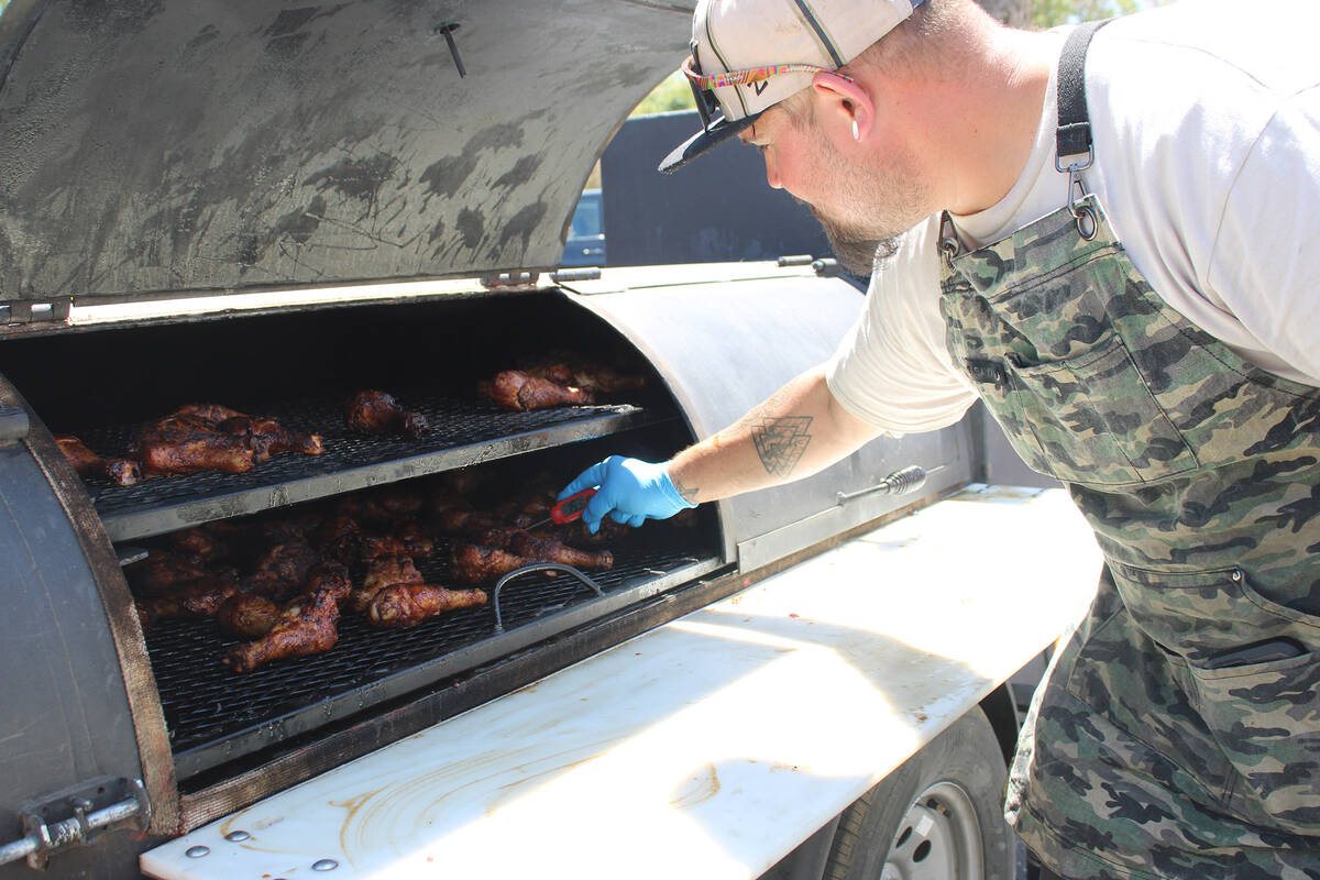 Rich Garibay, of the Las Vegas-based Green Eyez BBQ, checks some chicken he was ready to serve ...