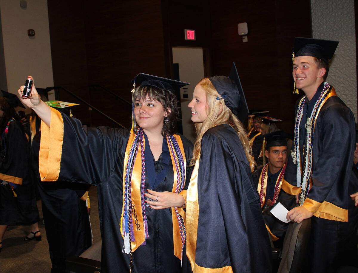 Prior to the ceremony, the seniors gathered in the school's theater to talk and get photos ...