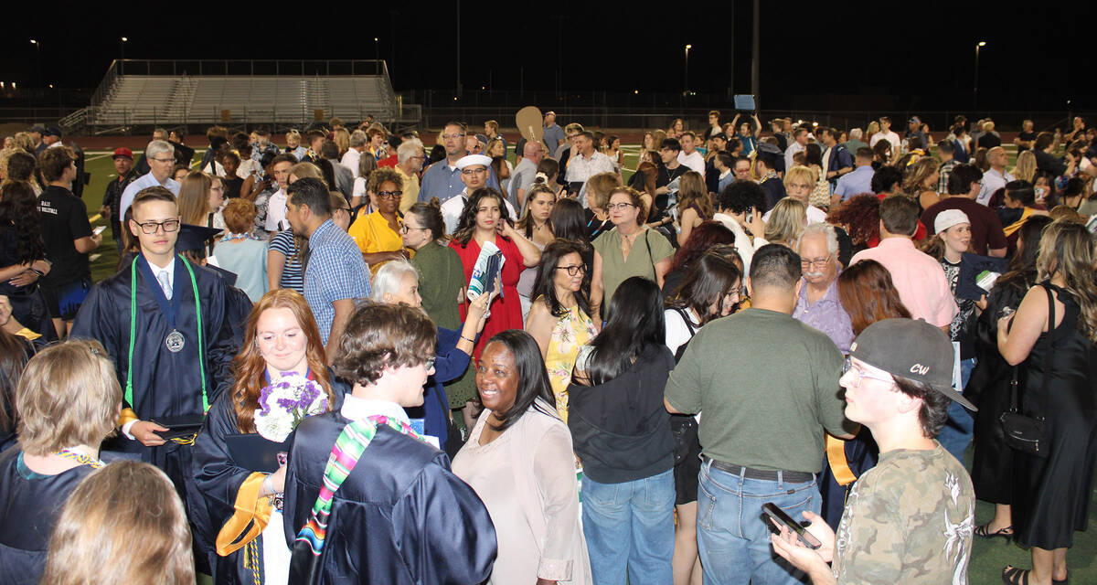Following the ceremony, the packed stadium of family, friends and schoolmates joined the gradua ...