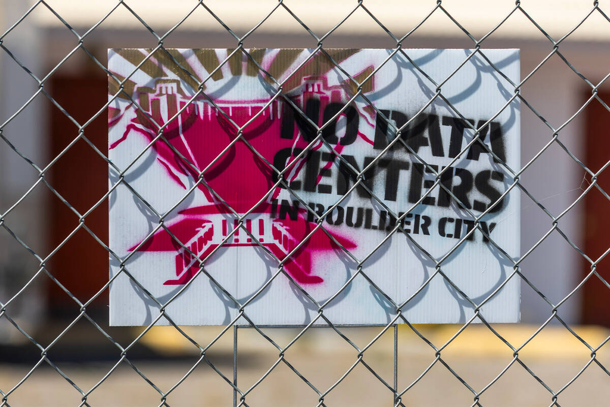 The gated Flamingo Inn Motel displays a "No Data Centers" sign on April 7, 2026, in Boulder Cit ...