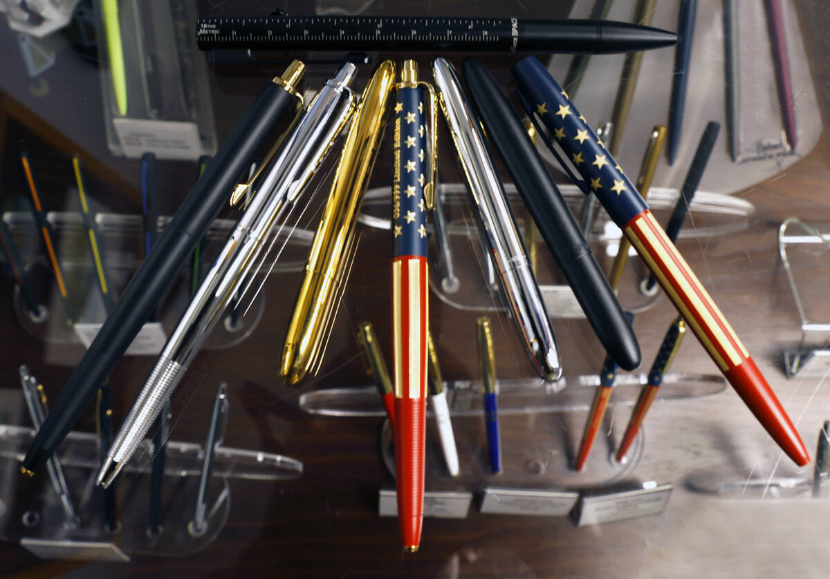 Various Fisher Space Pens, including a patriotic special-edition pen, center, celebrating the 2 ...