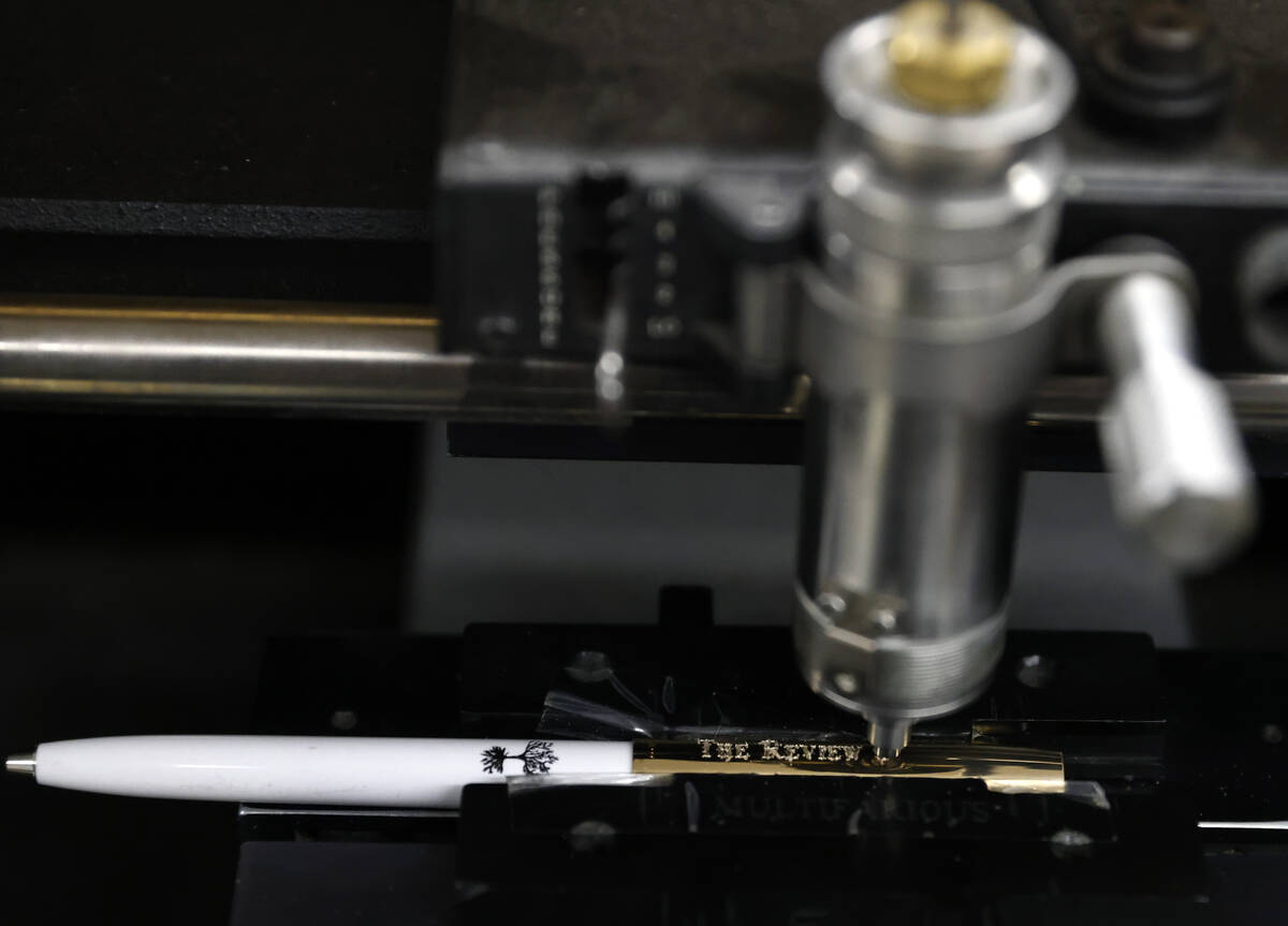A pen is seen being engraved at the Fisher Space Pen factory on May 13, 2026, in Boulder City. ...
